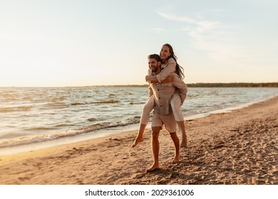 leisure and people concept - happy couple having fun on summer beach - Powered by Shutterstock