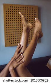 Leisure Relax At Home And Beauty Concept. Detail Of Black Woman Feet And Hands Showing French Manicure And Pedicure.