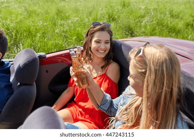 leisure, road trip, travel, summer holidays and people concept - happy friends driving in cabriolet car along country road and drinking beer - Powered by Shutterstock