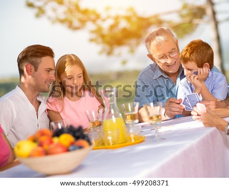leisure time family in countryside playing cards
