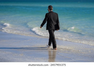 Leisure weekend and remote freelance work. Crazy comic business man in suit rest on sea bech. Rear view of back business man in suit in sea water at beach. Remote summer business. - Powered by Shutterstock