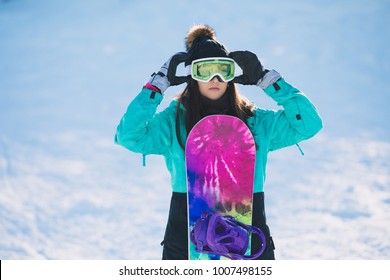 Leisure, Winter, Sport Concept - Happy Young Woman Snowboarder Standing With Board