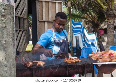 Lekki, Lagos State, Nigeria July 24,2018: Food Vendor Preparing Barbecue Chicken On A Grill 