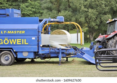 Lellingen, Luxembourg, July 6 2018. Bale Wrapper Wraps Corn Bales