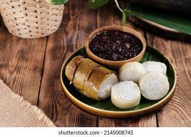 Lemang Tapai, is a typical Indonesia Padang food, made from white sticky rice, coconut milk and salt, then grilled in a bamboo stick and served with tapai, fermented black sticky rice. Selective focus - Shutterstock ID 2145008745