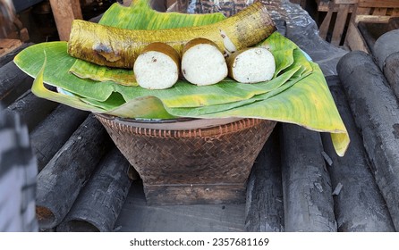 Lemang, a traditional food in the form of sticky rice wrapped in banana leaves, stuffed into bamboo, then grilled until cooked. - Shutterstock ID 2357681169