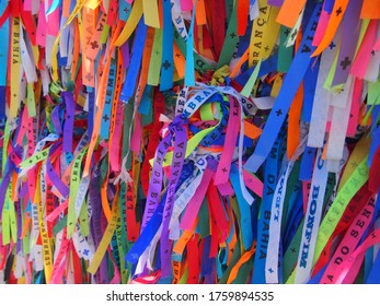 "LEMBRANCA DO SENHOR DO BONFIM DA BAHIA" written on a colorful Bonfim Ribbon. It means a gift from Lord Bonfin of Bahia, Igreja de Nosso Senhor do Bonfim, Salvador, Brazil