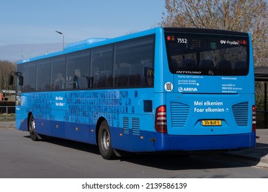 LEMMER, NETHERLANDS - MARCH 26 2022: Blue ARRIVA bus at the station of the Dutch village of Lemmer. Dutch and Frisian text 'For each other - With each other' on the side and back of the bus