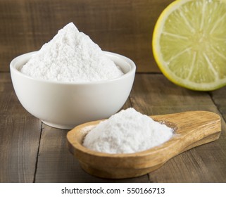 Lemon And Baking Soda On Wooden Table