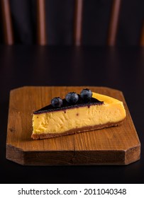 Lemon Blueberry Cheesecake On A Dark Background. Copy Space