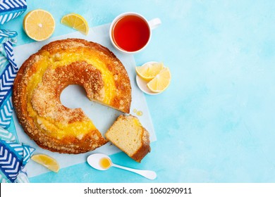 Lemon Bundt Cake With Cup Of Tea. Blue Background. Top View. Copy Space.