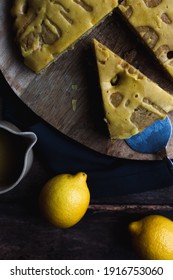 Lemon Cake With Olive Oil On A Wooden Cutting Board On A Vintage Wooden Table.