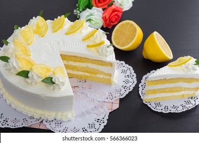Lemon cake and piece of lemon on black background
