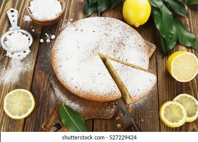 Lemon cake with sugar powder on the wooden table