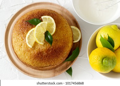 Lemon cake with whipped cream on a light background. Selective focus.