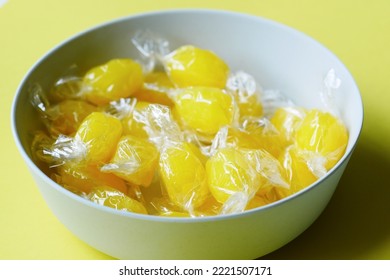 Lemon Candy In A Bowl On Yellow Background 