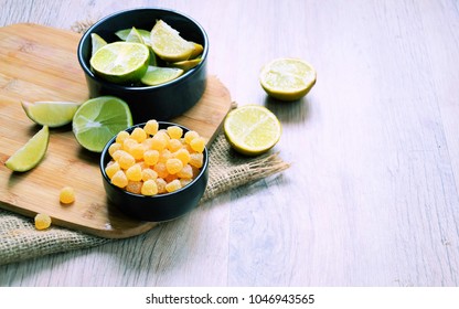 Lemon Candy And Fresh Lemon On A Wooden Table