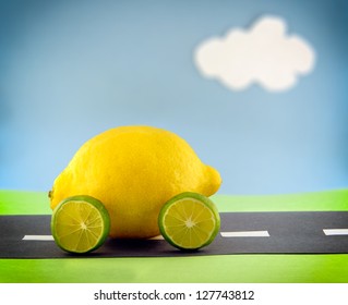 A Lemon Car With Lime Wheels Driving Along A Construction Paper Scene.  Scene Made By The Photographer.