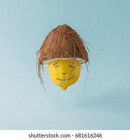 Lemon With Coconut Hat On Pastel Blue Background. Funny Food Creative Concept.