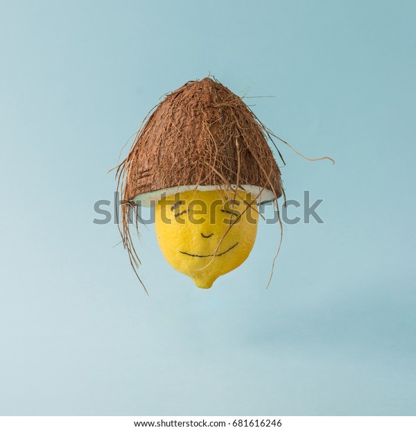 パステル青の背景にレモンとココナツ帽 面白い食べ物のクリエイティブコンセプト の写真素材 今すぐ編集