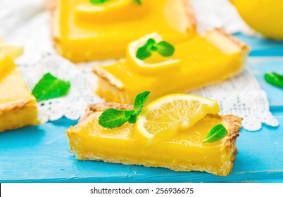 the lemon cream pie cut on pieces and decorated with fresh mint. selective focus.