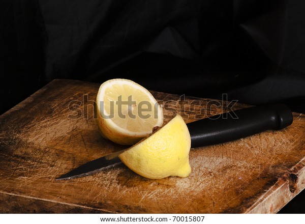 Lemon cut by a\
knife.