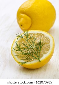 Lemon And Dill On A White Wooden Background