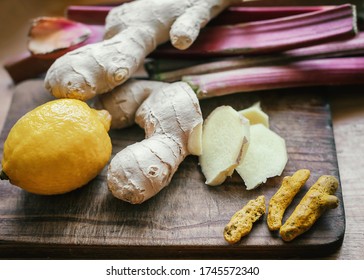 Lemon, Ginger Root, Rhubarb, Dry Turmeric Root On A Wooden Board. All-natural Health Hacks To Boost Your Immune System.