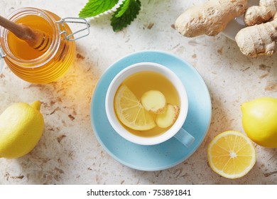 Lemon and ginger tea with honey. Cup of hot honey lemon tea with fresh ginger root. - Powered by Shutterstock