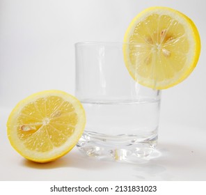 Lemon With Glass Of Water On White Background No People Stock Photo