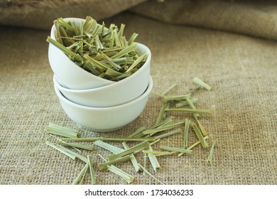 Lemon Grass (Cymbopogon Citratus, Capim Limao, Santo). Pile Of Dried Lemongrass In White Bowl. Dried Sprigs Of Natural Lemongrass, Dried Herb, Herbal Medicine. Selective Focus, Closeup