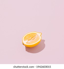 Lemon Half On A Pale Pink Background. Sunlit Vintage Yellow Summer Fruit With Shadow. Retro Beach Food Aesthetic Layout.