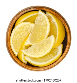 Lemon Half In Wooden Bowl. Freshly Cut Ripe Yellow Edible Citrus Fruit. Citrus Limon. Lemon Juice Is Used For Culinary Purposes And For Cleaning. Close Up, From Above, Over White, Isolated Food Photo.