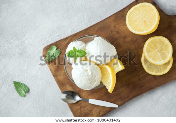 Lemon Ice Cream in bowl. Homemade citrus lemon ice\
cream with mint close up.