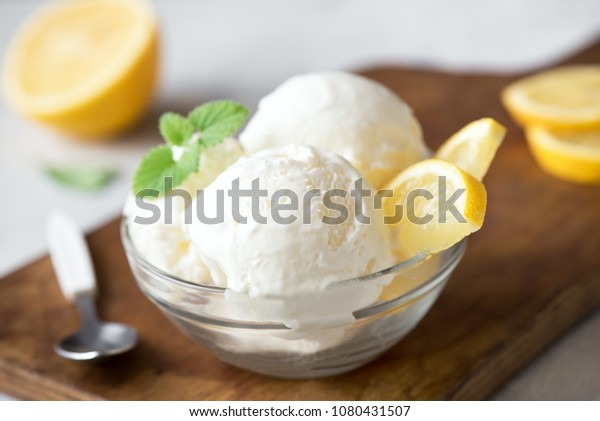 Lemon Ice Cream in bowl. Homemade citrus lemon ice\
cream with mint close up.
