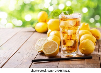 Lemon Iced Tea With Fresh Fruits On A Wooden Table