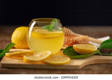 Lemon Juice With Honey On Wooden Table,  Lemons And Sage Leaves.