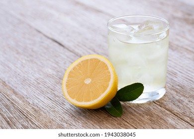 Lemon Juice Or Lemonade With Yellow Limon Slice On Wooden Table Background. Copy Space.