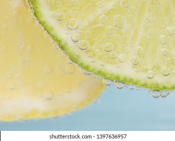 Lemon And Lime Slices Photographed In Seltzer Water.