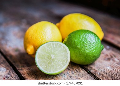 Lemon and limes on rustic wood
