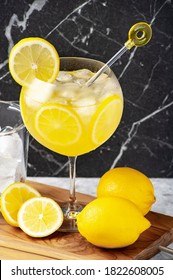  Lemon Limoncello Cocktail In A Glass Over A Wooden Table, Marble Background