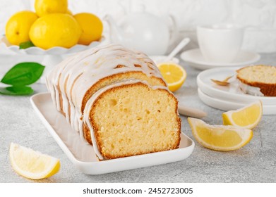 Lemon loaf cake with sugar icing on a white plate on a stone background. Copy space - Powered by Shutterstock