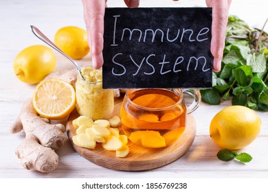  Lemon, mint leaves, ginger and honey on a wooden table. Antiviral treatment. - Shutterstock ID 1856769238
