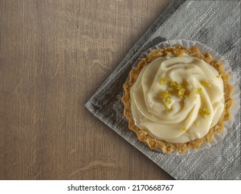 Lemon Mousse Pie On A Piece Of Cloth Or Fabric And Wooden Surface. Traditional Brazilian Dessert Snack On Afternoon. Top View Shot, Copy Space