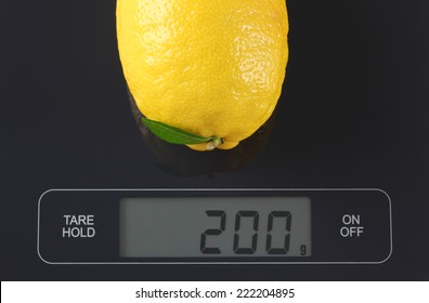 Lemon On Digital Scale Displaying 200 Gram.