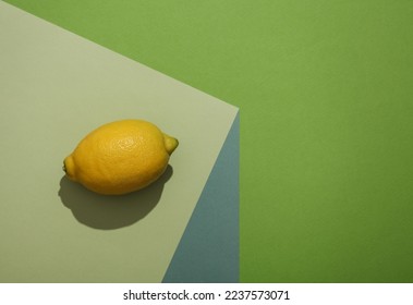 Lemon on a paper cube. Optical illusion. Geometric composition. Minimalistic creative layout - Shutterstock ID 2237573071