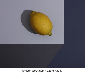 Lemon on a paper cube. Optical illusion. Geometric composition. Minimalistic creative layout - Shutterstock ID 2237573267