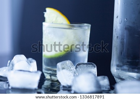 lemon on vodka with ice on table