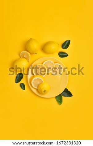 Lemon on yellow background flat lay image.