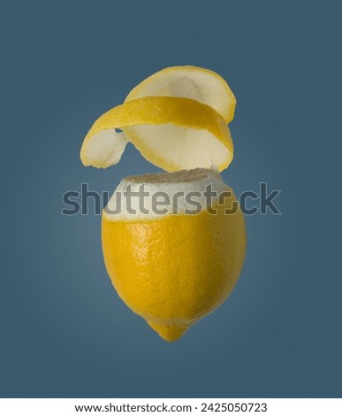 lemon with peel on a blue background, isolate, flying food